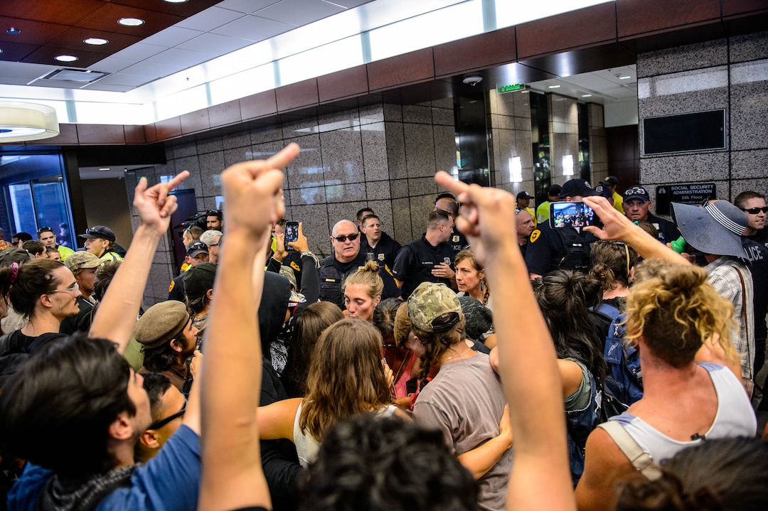 (Trent Nelson  |  The Salt Lake Tribune)  Police attempt to remove protesters occupying the Chamber of Commerce Building Salt Lake City on Tuesday, July 9, 2019. Dozens of people showed up to protest the proposed Inland Port and ended up clashing with police, resulting in temporary street closures and arrests.