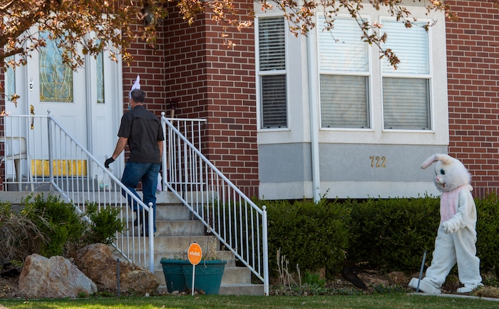 (Rick Egan  |  The Salt Lake Tribune)     Rhett Ogden and Makea Kelly, dressed as the Easter Bunny,  go door-to-door as they assist Draper City Parks and Recreation workers, the police and the fire department, as they deliver more than 30,000 Easter eggs to children at their doorsteps in Draper, Friday, April 10.
