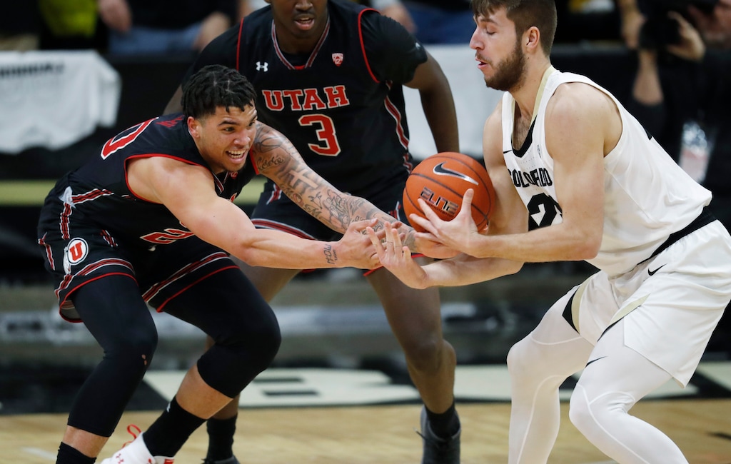 Utah forward Timmy Allen, left, and Colorado forward Lucas Siewert vie for possession of the ball during the first half of an NCAA college basketball game Saturday, March 2, 2019, in Boulder, Colo. (AP Photo/David Zalubowski)