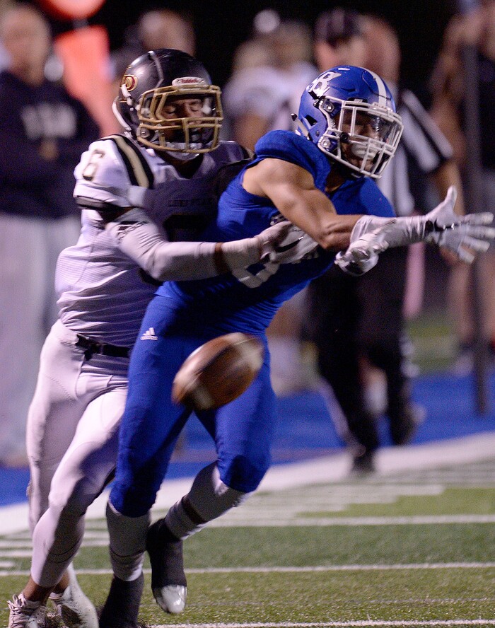 (Leah Hogsten | The Salt Lake Tribune) Bingham's Tanner Merril tries to make the catch for an interception ahead of Lone Peak's Carson Stosich. Bingham High School leads Lone Peak High School, 14-3 during their game Friday, September 28, 2017 in South Jordan.