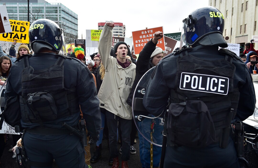 (Scott Sommerdorf   |  The Salt Lake Tribune)   Protestors shout "This is what democracy looks like!" as they confront SLCPD as they blocked State Street near 100 South after President Trump's visit to Salt Lake City, Monday, December 4, 2017.  
