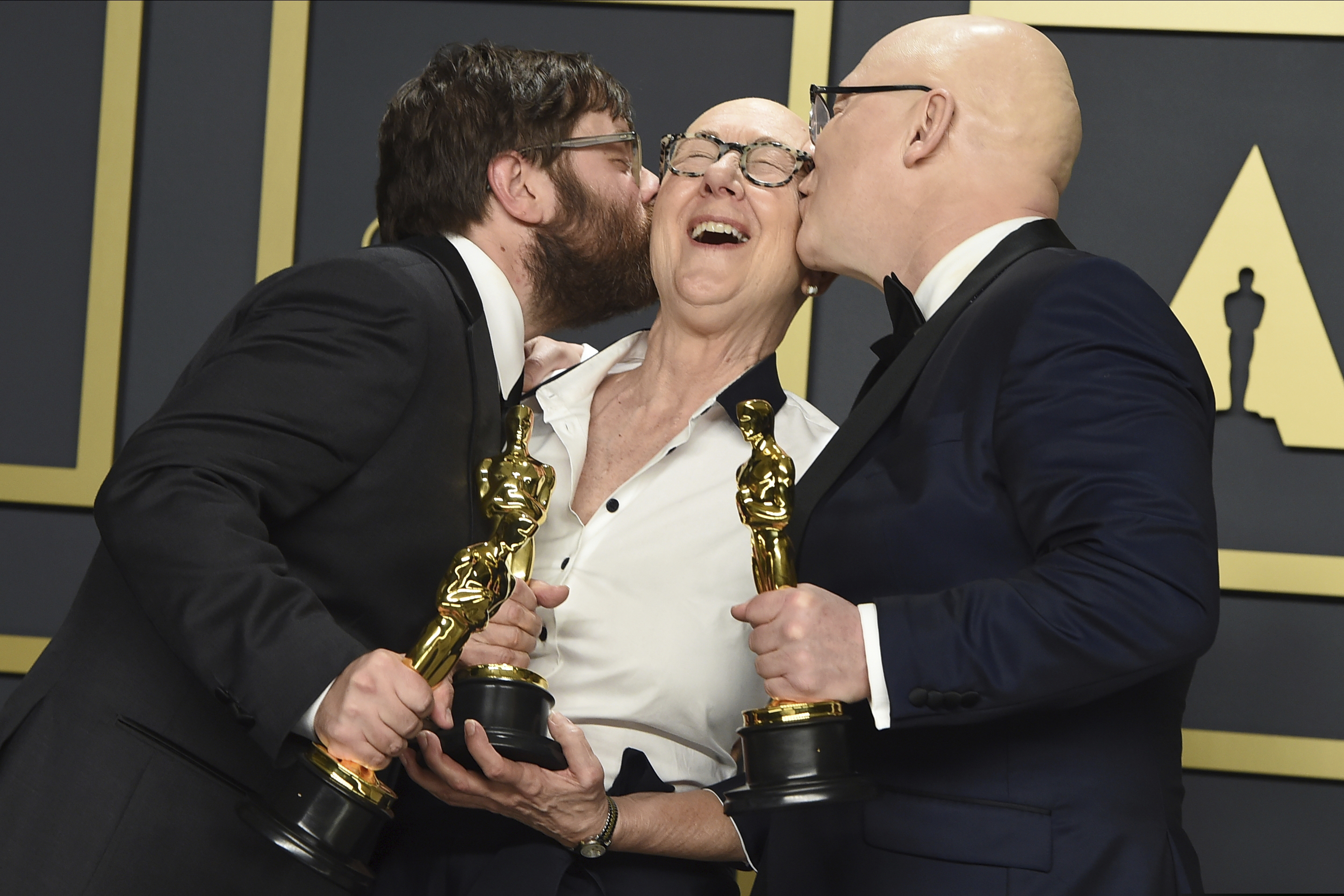 (Jordan Strauss | Invision/AP)  Jeff Reichert, from left, Julia Reichert, and Steven Bognar, winners of the award for best documentary feature for "American Factory", pose in the press room at the Oscars on Sunday, Feb. 9, 2020, at the Dolby Theatre in Los Angeles.