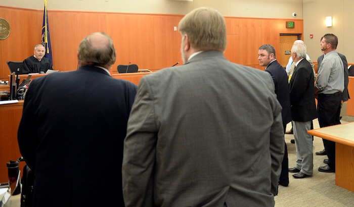 (Al Hartmann | Tribune file photo) Prosecuters, left, speak to Judge Kent Holmberg in Third District Court in Park City on July 17, 2017 . At right defense lawyers huddle with their clients former Daggett County Sheriff Jerry Jorgensen, former jail commander Lt. Benjamin Lail and Deputy Joshua Cox. The three are charged in connection with the abuse of jail inmates.