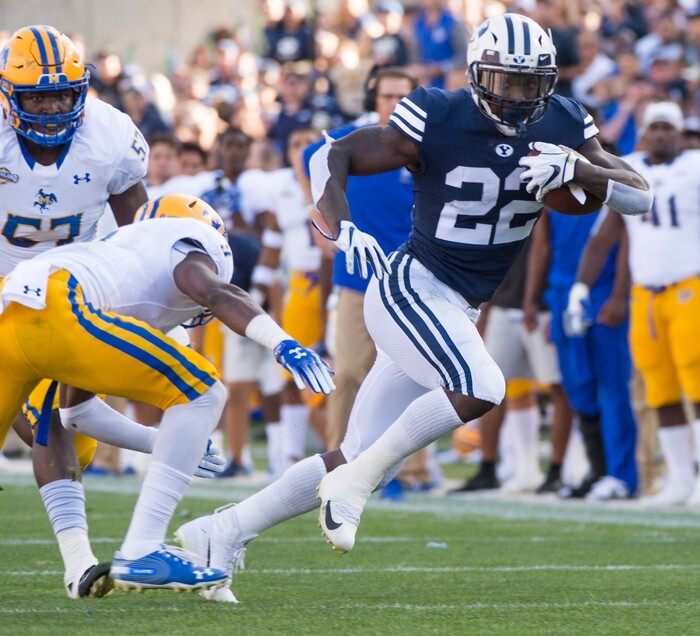 (Rick Egan  |  The Salt Lake Tribune)    Brigham Young Cougars running back Squally Canada (22) gets past McNeese State Cowboys defensive lineman Cody Roscoe (57) and McNeese State Cowboys defensive back Trent Jackson (9), in football action Brigham Young Cougars vs McNeese State Cowboys at Lavell Edwards Stadium, Saturday, Sept. 22, 2018.


