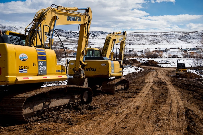 (Trent Nelson | The Salt Lake Tribune)  Excavators at the site of a new development in Coalville, Friday March 2, 2018.