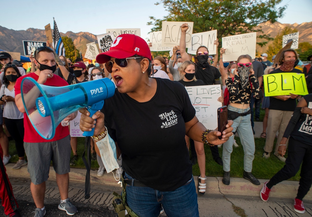 (Rick Egan  |  The Salt Lake Tribune)   Lex Scott from Black Lives Matter Utah, leads chant as counter protesters stand across the street at Cottonwood Heights police station on Monday, Aug. 3, 2020.