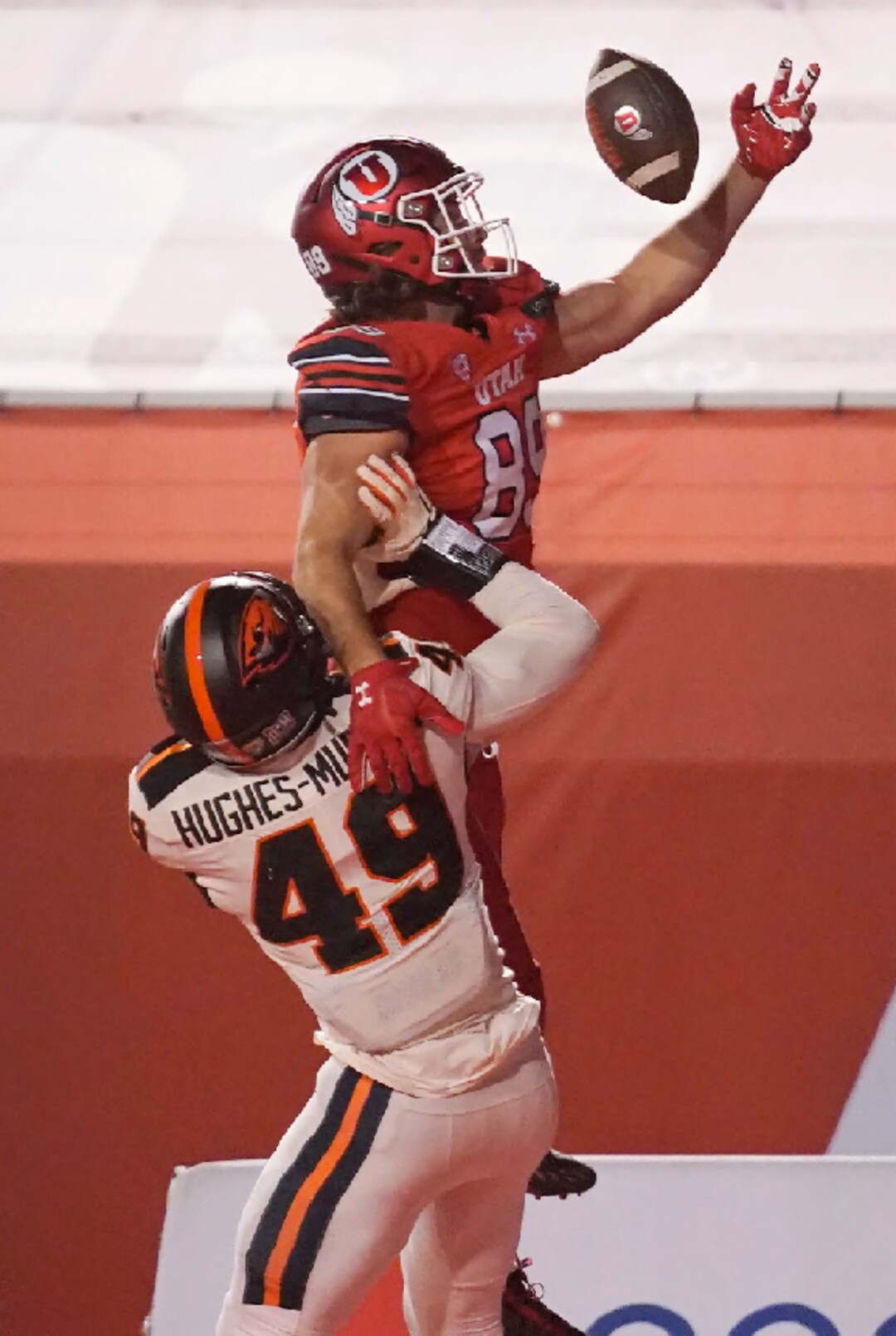 Oregon State linebacker Andrzej Hughes-Murray (49) defends against Utah tight end Cole Fotheringham (89), who catches the ball but lands out of bounds during the first half of an NCAA college football game Saturday, Dec. 5, 2020, in Salt Lake City. (AP Photo/Rick Bowmer)