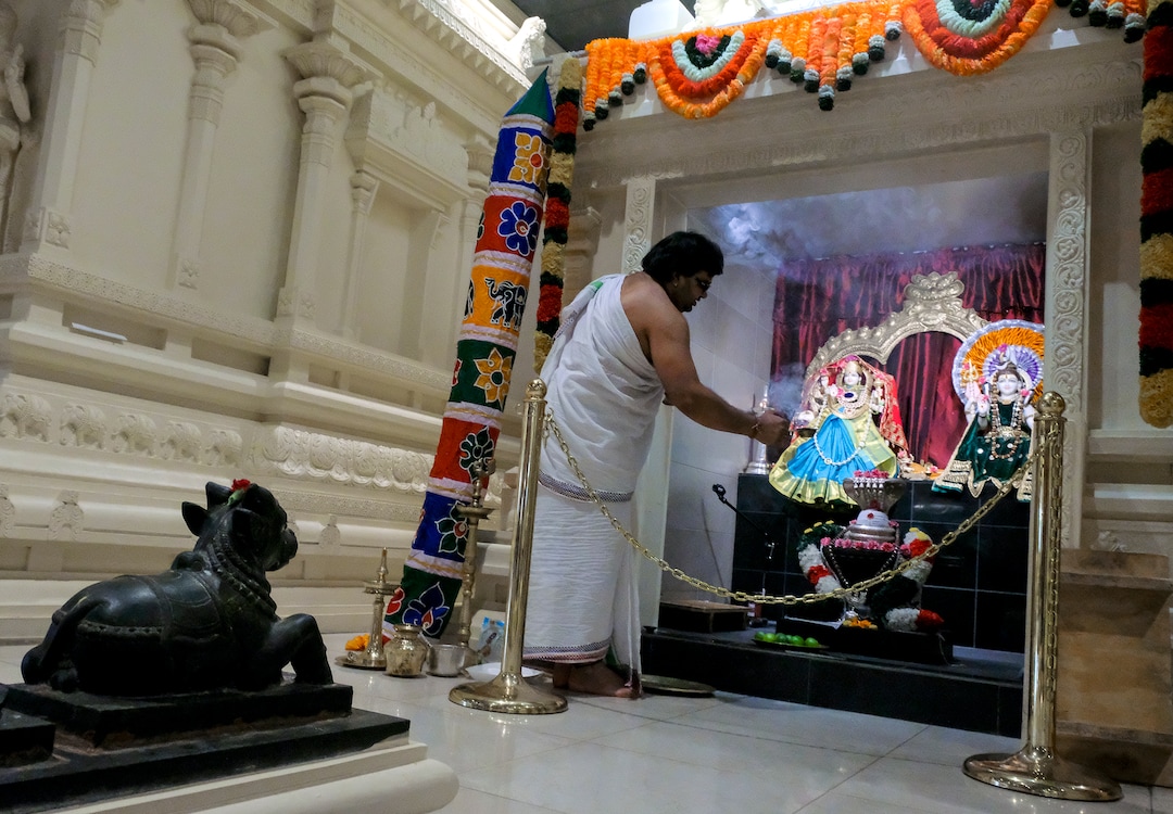 Leah Hogsten  |  The Salt Lake Tribune  Sri Ganesha Hindu Temple priest Sathish Nivarthi makes offerings to deities Shiva and Durga, March 28, 2019. Hindu priests act as a kind of mediator between the worshipper and the deity, performing rituals to the deities on behalf of the worshippers. Artisans from around the world spent two years hand-carving deities in the Sri Ganesha Hindu Temple in South Jordan.