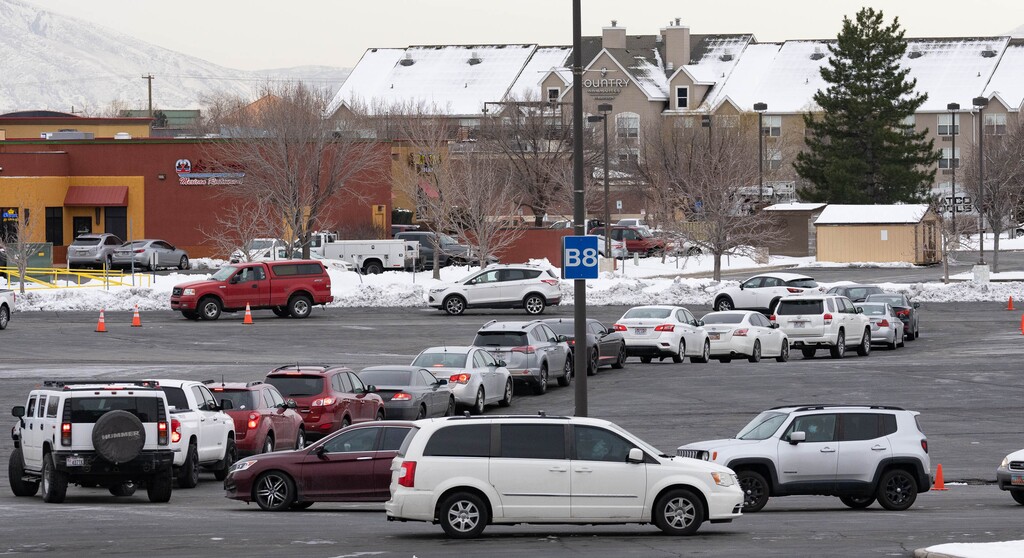 (Francisco Kjolseth | The Salt Lake Tribune) Long lines of cars snake around the Maverik Center in West Valley City on Tuesday, Jan. 4, 2022, as people wait for COVID-19 testing.