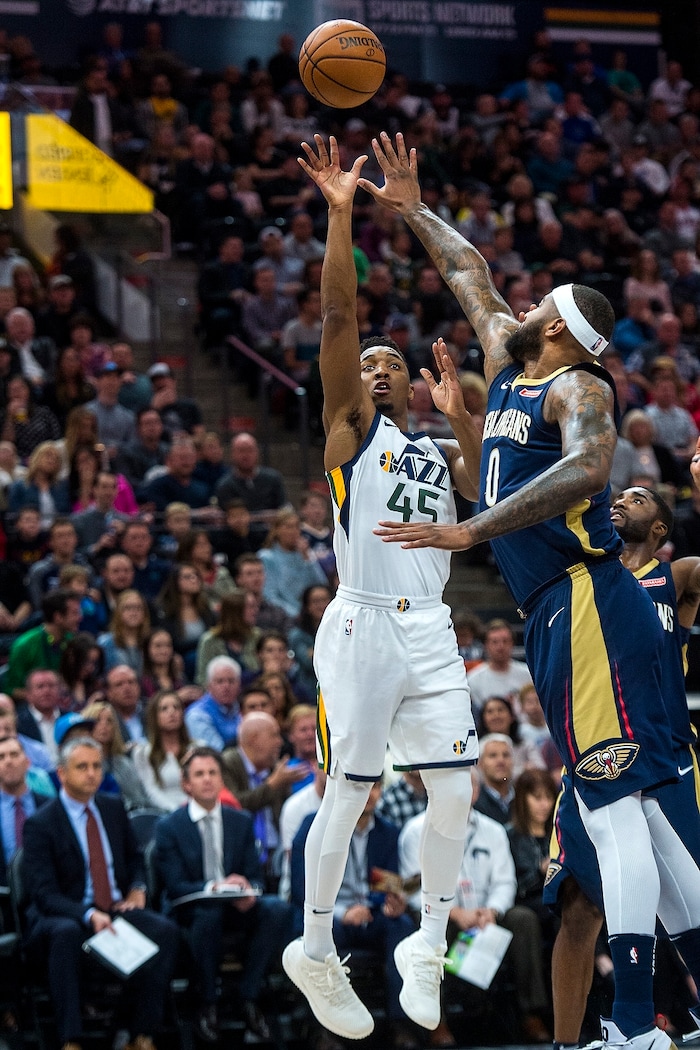 (Chris Detrick  |  The Salt Lake Tribune)  Utah Jazz guard Donovan Mitchell (45) shoots past New Orleans Pelicans center DeMarcus Cousins (0) during the game at Vivint Smart Home Arena Friday, December 1, 2017.  
