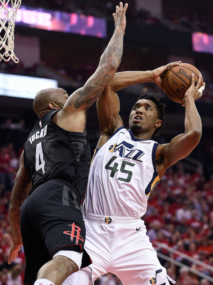 Utah Jazz guard Donovan Mitchell (45) drives to the basket as Houston Rockets forward PJ Tucker defends during the second half in Game 2 of an NBA basketball second-round playoff series, Wednesday, May 2, 2018, in Houston. The Jazz won 116-108. (AP Photo/Eric Christian Smith)