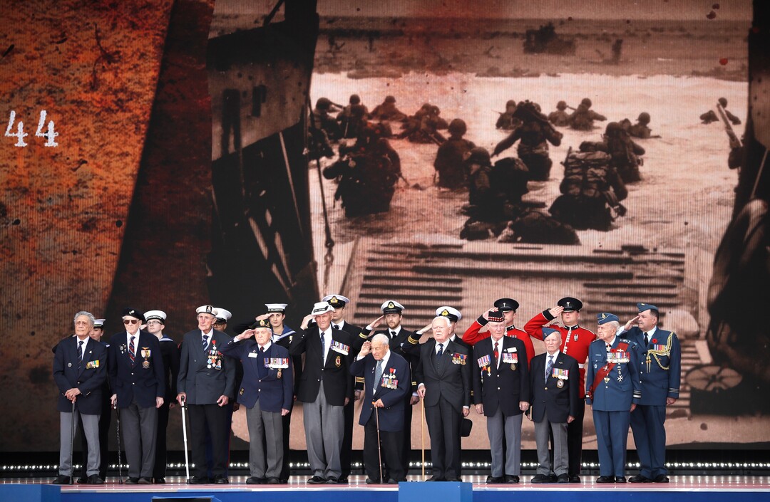 (Matt Dunham | AP) D-Day veterans, front row, stand on stage during an event to mark the 75th anniversary of D-Day in Portsmouth, England Wednesday, June 5, 2019. World leaders including U.S. President Donald Trump are gathering Wednesday on the south coast of England to mark the 75th anniversary of the D-Day landings.