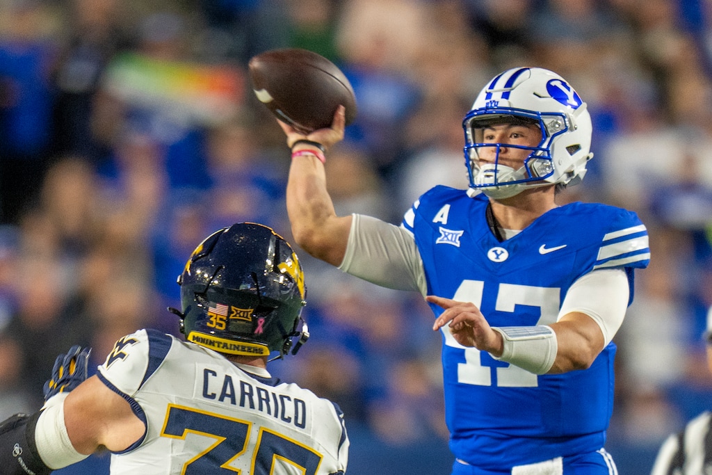 (Rick Egan | The Salt Lake Tribune) BYU Cougars quarterback Bear Bachmeier (47) throws a pass, as West Virginia Mountaineers linebacker Reid Carrico (35) defends in action between the BYU Cougars the West Virginia Mountaineers at Lavell Edwards Stadium in Provo, on, in Friday, Oct. 3, 2025.