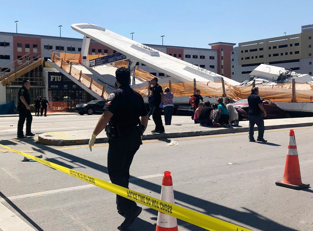 (WTVJ NBC6 via AP) Emergency personnel work at the scene of a collapsed pedestrian bridge at Florida International University on Thursday, March 15, 2018, in the Miami area. The brand-new pedestrian bridge collapsed onto a highway crushing multiple vehicles and killing several people.