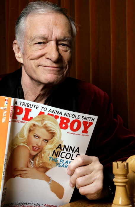 (Damian Dovarganes | The Associated Press) In this April 5, 2007 file photo, Playboy Enterprises founder Hugh Hefner poses with a copy of Playboy magazine featuring Anna Nicole Smith as Playmate of the Year, at the Playboy Mansion in Los Angeles. The magazine that helped usher in the sexual revolution in the 1950s and '60s by bringing nudity into America's living rooms announced this week that it will no longer run photos of completely naked women. Starting in March, 2016, Playboy's print edition will still feature women in provocative poses, but they will no longer be fully nude.