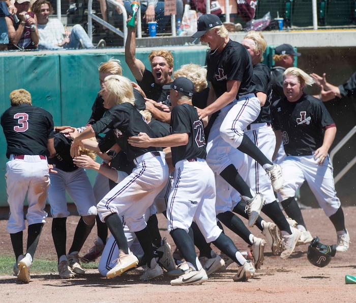 (Rick Egan  |  The Salt Lake Tribune)   Jordan High celebrates their 11-1 win over Olympus, for the 5A state baseball championship, at UVU in Orem, Friday, May 25, 2018.