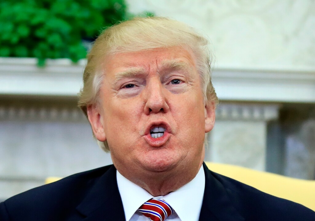 In this Feb. 14, 2018 photo, President Donald Trump speaks about domestic violence during a working session regarding the opportunity zones provided by tax reform in the Oval Office of the White House in Washington. The New Yorker has obtained an eight-page, hand-written account written by a former Playboy Playmate who said she had a nine-month extramarital affair with Donald Trump beginning in 2006.  (AP Photo/Manuel Balce Ceneta)