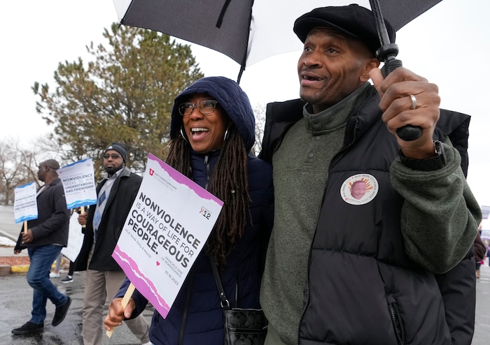 (Leah Hogsten | The Salt Lake Tribune) Crystal Rudds and her friend Jerome Battle, right, participate in the march from East High School to Kingsbury Hall on Monday. To commemorate the legacy and work of Martin Luther King, Jr. and many other activists fighting for racial equality during the Civil Rights movement, the University of Utah's office of Equity, Diversity & Inclusion kicked off MLK Week 2023 with a rally at East High School, followed by a march to Kingsbury Hall, Jan. 16, 2023. 