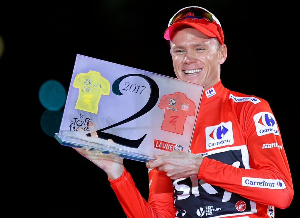 Britain's Chris Froome celebrates on podium after winning the Spanish Vuelta cycling race, in Madrid, Sunday, Sept. 9, 2017. The special trophy he holds was given to him as he won both the Tour de France and La Vuelta. (AP Photo/Francisco Seco)