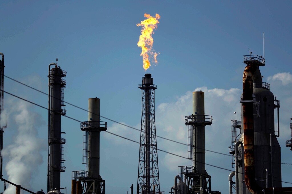 (Gregory Bull | AP file photo) A flame burns at the Shell Deer Park oil refinery in Deer Park, Texas, on Thursday, Aug. 31, 2017. Oil prices are plunging Sunday, March 8, 2020, amid worries that an OPEC dispute will lead a virus-weakened economy to be awash in an oversupply of crude.