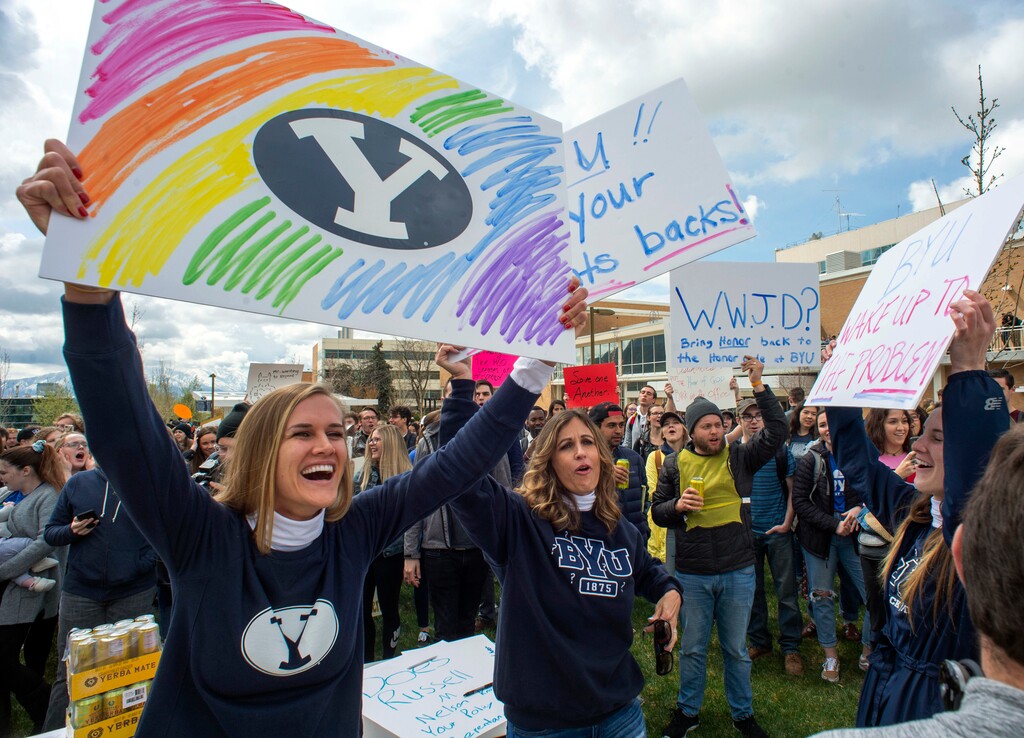 (Rick Egan | The Salt Lake Tribune) In this April 12, 2019, file photo, Sidney Draughon holds a sign as she takes part in a protest in Provo, Utah, against how the Brigham Young University Honor Code Office investigates and disciplines students.