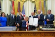 (Julia Demaree Nikhinson | AP) President Donald Trump holds a signed executive order in the Oval Office of the White House, Monday, July 13, 2026, in Washington. Behind Trump, from left: U.S. Reps. Celeste Maloy and Mike Kennedy; U.S. Sens. John Curtis and Mike Lee; Gov. Spencer Cox; and House Speaker Mike Schultz.