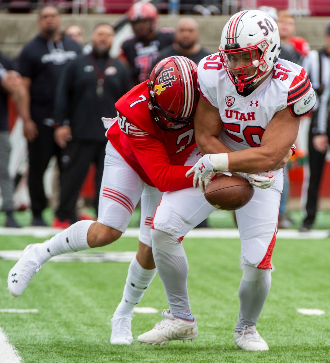 (Rick Egan  |  The Salt Lake Tribune)  Quarterback Cameraon Rising, (7) attempts to wrestle the ball back, after offensive lineman, Orlando Umana pickup his fumble, for a receiver, in Utah's spring Red-White game at Rice-Eccles Stadium, Saturday, April 13, 2019.