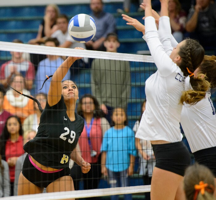 (Steve Griffin | The Salt Lake Tribune) Herriman's Jasmyne Love tips a shot past the Copper Hills defense during volleyball match at Copper Hills High School in West Jordan Tuesday September 26, 2017.