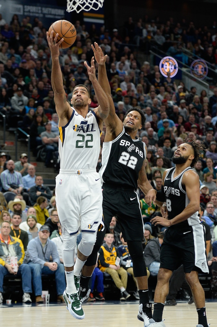 (Francisco Kjolseth  |  The Salt Lake Tribune)  Utah Jazz forward Thabo Sefolosha (22) lays one up past San Antonio Spurs forward Rudy Gay (22) during the second half of the NBA basketball game in Salt Lake City, Thursday, Dec. 21, 2017.