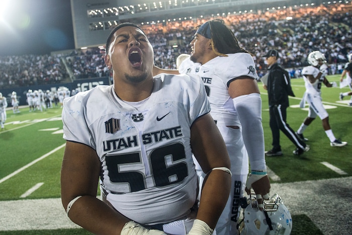 (Chris Detrick  |  The Salt Lake Tribune)  Utah State Aggies nose tackle Gasetoto Schuster (56) cheers during the game at Merlin Olsen Field at Maverik Stadium Friday, September 29, 2017. Utah State Aggies defeated Brigham Young Cougars 40-24.