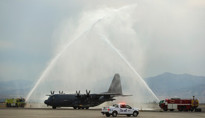 (Steve Griffin  |  Deseret News, pool photo)  A  C130-J carrying the  casket of Draper Battalion Chief Matt Burchett taxis through a water arch as it lands at the Utah Air National Guard Base in Salt Lake City on Wednesday, Aug. 15, 2018. Burchett was killed while fighting the Mendocino Complex Fire north of San Francisco.