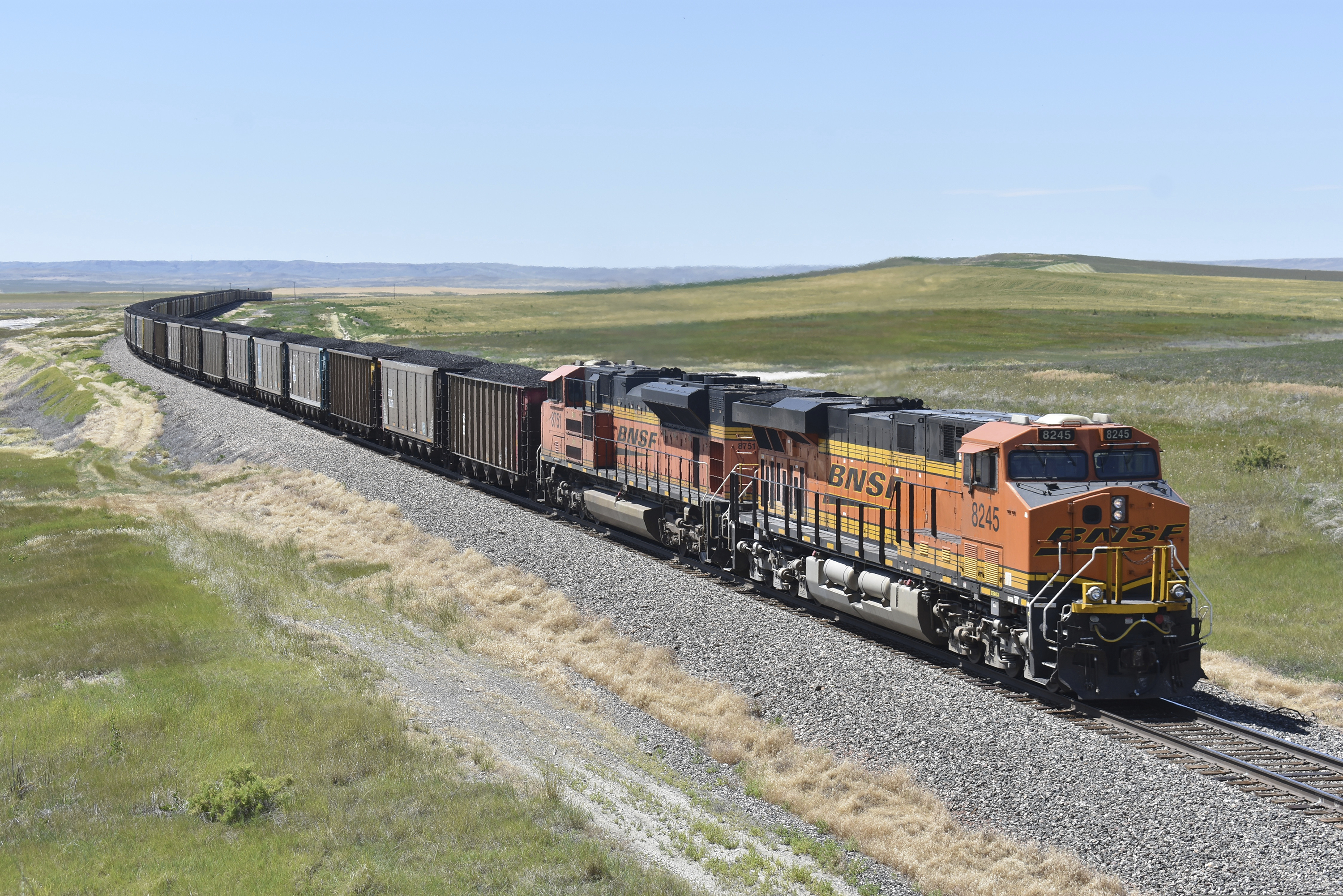 (Matthew Brown | AP) A BNSF Railway train hauling carloads of coal from the Powder River Basin of Montana and Wyoming is seen east of Hardin, Mont., on July 15, 2020. A coalition of states is renewing its push to stop the Trump administration from selling coal from public lands.