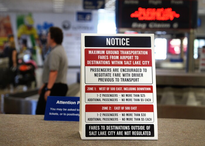 Scott Sommerdorf   |  The Salt Lake Tribune  A sign sits atop the luggage carousel at the Salt Lake International Airport warning travelers to negotiate their fare with taxi drivers, Wednesday, July 20, 2016.  There have been some complaints from airport visitors about largely unregulated taxi fares. Cabs no longer need to have meters, can largely charge any fare they want (with some exceptions in SLC itself), and need not tell passengers in advance how much they will charge.
