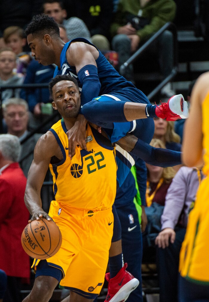(Rick Egan  |  The Salt Lake Tribune)     Minnesota Timberwolves forward Kelan Martin (30) sails over the top of Utah Jazz forward Jeff Green (22), in NBA action between the Utah Jazz and the Minnesota Timberwolves in Salt Lake City, Monday, Nov. 18, 2019.