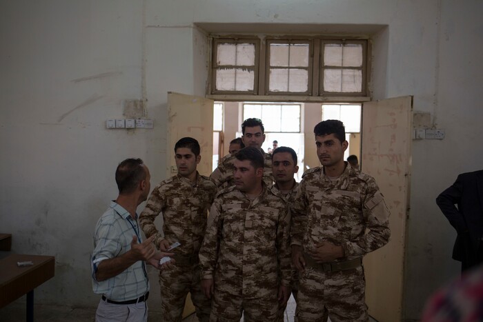 Kurdish security officials receive instructions at a polling station in the disputed city of Kirkuk, Monday Sept. 25, 2017. Iraq's Kurdish region vote in a referendum on whether to secede from Iraq. The vote has cause tensions in Kirkuk which is divided between Kurds, Turkmen and Arabs. (AP Photo/Bram Janssen)