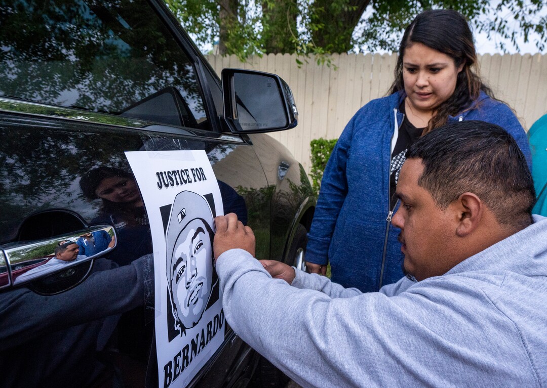 (Rick Egan | The Salt Lake Tribune) Carlos Torres and Griselda Romero tape a "Justice for Bernardo" sign on their car before driving to the Salt Lake City Cemetery, after the "Long Live Loske" gathering at Rose Park on Saturday, May 22, 2021. The family of Bernardo Palacios-Carbajal hosted a "1st Heavenly Anniversary" event to celebrate the life of their son and brother to mark the 1-year anniversary of his death on May 23, 2020 by Salt Lake City Police, who fired 34 shots, killing the 22-year-old man.
