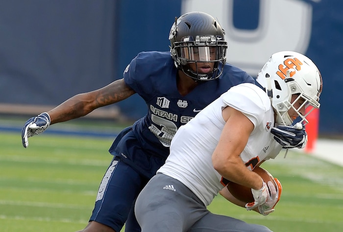 Utah State cornerback Ja'Marcus Ingram tackles Idaho State wide receiver Hagen Graves during an NCAA football game Thursday, Sept. 7, 2017, in Logan, Utah. (Eli Lucero/Herald Journal via AP)