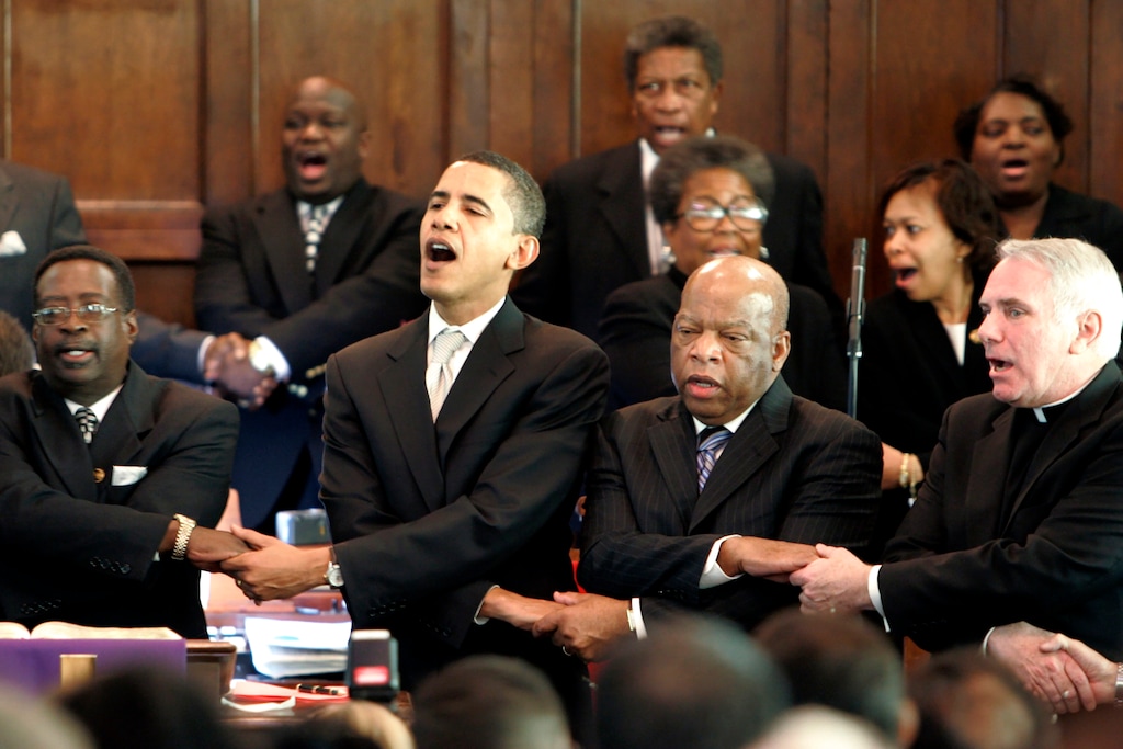 (AP Photo/Rob Carr, File) In this Sunday March 4, 2007, file photo, from left, Brown Chapel AME Church Pastor James Jackson, Democratic presidential candidate Sen. Barack Obama, D-Ill., U.S. Rep. John Lewis, D-Ga., and Rev. Clete Kiley, hold hands and sing at the end of a church service in Selma, Ala., on the commemoration of the Rev. Martin Luther King Jr. protest march from Selma to Montgomery, Ala. Lewis, who carried the struggle against racial discrimination from Southern battlegrounds of the 1960s to the halls of Congress, died Friday, July 17, 2020.