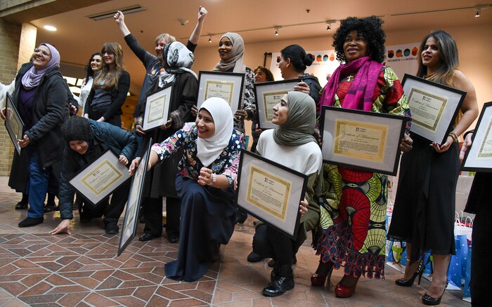 (Francisco Kjolseth  |  The Salt Lake Tribune)  Women of the World presents their 8th annual award ceremony at the Salt Lake County building in Salt Lake City on Saturday, Dec. 8, 2018, as a celebration of successes including educational, service, and employment milestones by refugee women who gather for a group photo with their certificates of achievement. 