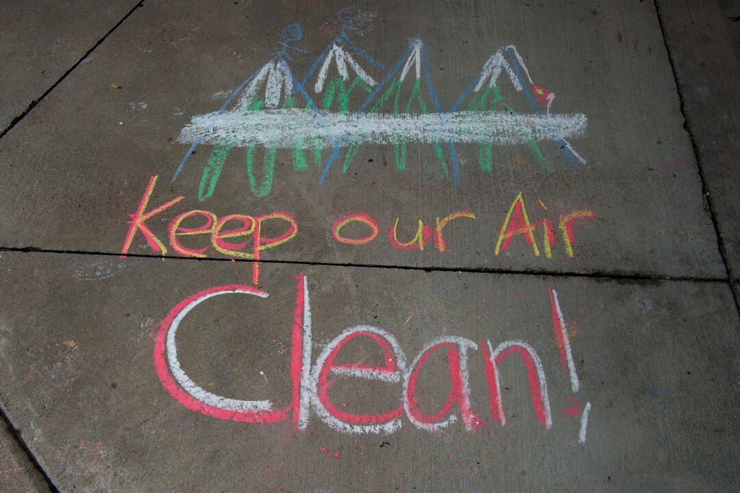 (Rick Egan  |  The Salt Lake Tribune)   Carolyn Hoffert and Angie Parkin and their kids draw chalk art on the sidewalk at Lehi City Hall to protest the expansion of Geneva Rock's mining activities near their neighborhood, Tuesday, April 2, 2019.