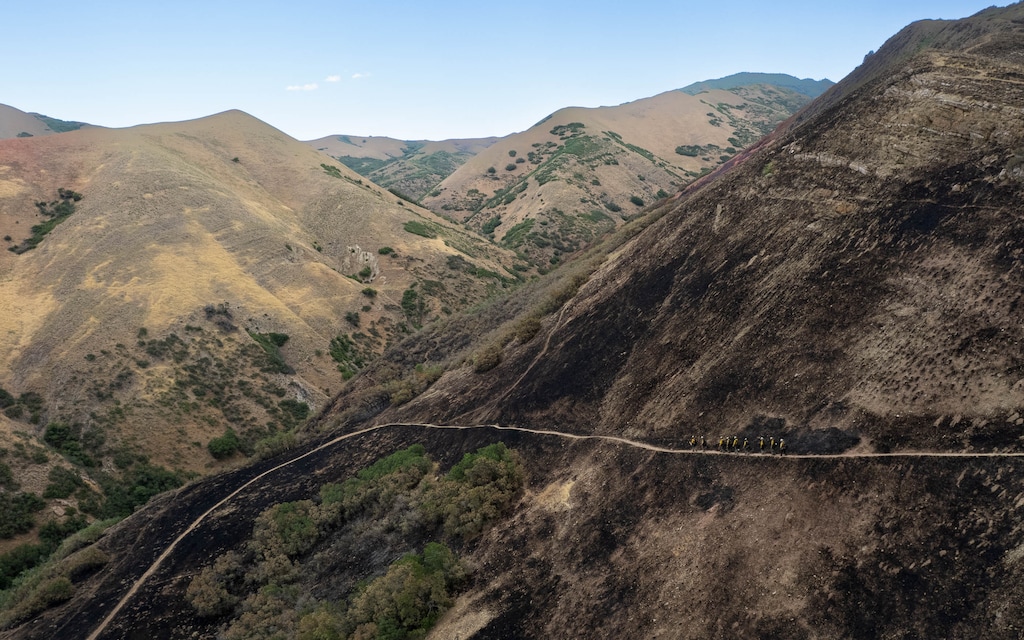 (Francisco Kjolseth | The Salt Lake Tribune) A fire crew walks down among the burn scar from the Bonneville Fire above the Salt Lake Valley on Thursday, June 25, 2026.