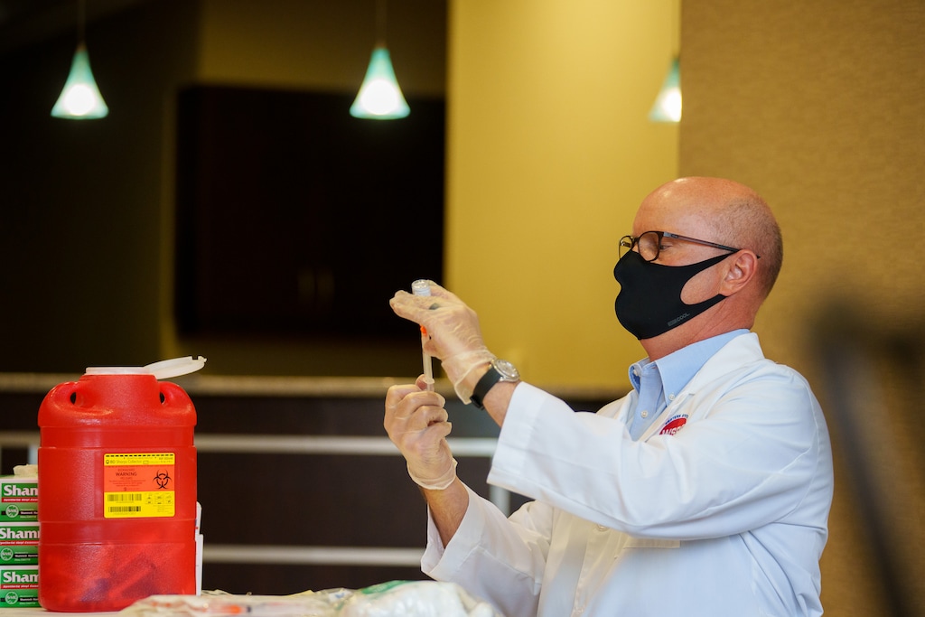 (Trent Nelson | The Salt Lake Tribune) Pharmacist Kevin DeMass with a dose of the Moderna vaccine at The Apothecary Shoppe in Salt Lake City on Friday, May 21, 2021.