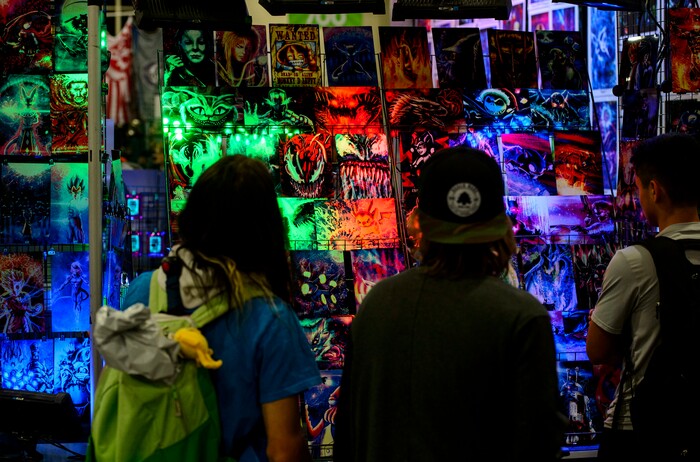 (Steve Griffin  |  The Salt Lake Tribune)  People stop to look at art work at the Salt Lake Comic Con in Salt Lake City Friday September 22, 2017.