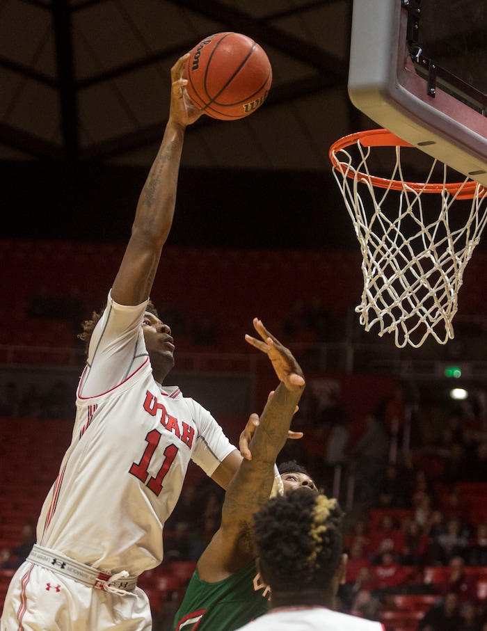 (Rick Egan  |  The Salt Lake Tribune)  Utah Utes forward Chris Seeley (11) dunks the ball over Mississippi Valley State Delta Devils center Jamal Watson (33), in basketball action Utah Utes vs. Mississippi Valley State Delta Devils, at the Jon M. Huntsman Center,  Monday, November 13, 2017.