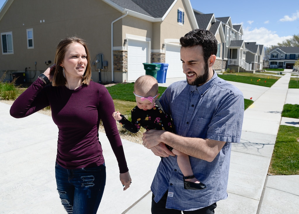 (Francisco Kjolseth | Tribune file photo) Ember and Jeremy Ulrich take their daughter Jemma, 1, for a walk around their newly developed neighborhood in Lehi. Jeremy wanted to be closer to his job at Adobe in Lehi, which is in fast growing Utah County.