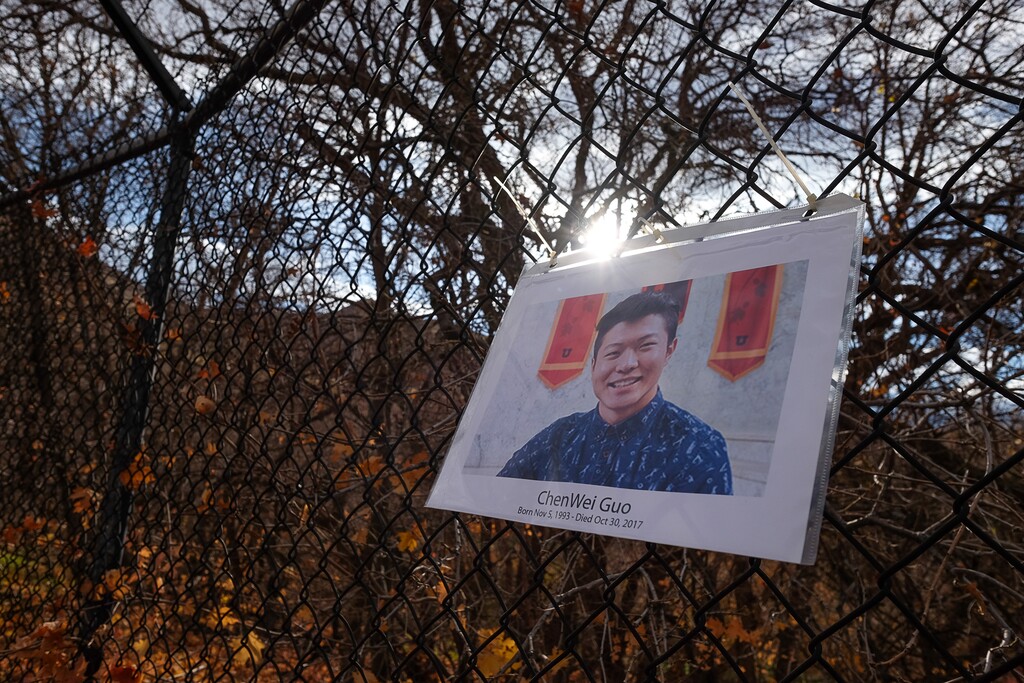 (Francisco Kjolseth  |  The Salt Lake Tribune)  A photo of  University of Utah student ChenWei Guo, 23, hangs on the fence above Red Butte Garden on Friday, Nov. 3, 2017, near where he was killed during an attempted car jacking Monday night. 