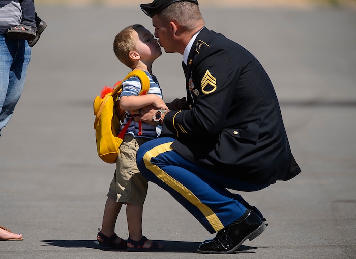 (Trent Nelson | The Salt Lake Tribune)  Robert Barton kisses his father, Jesse Barton (cousin of Aaron Butler) while waiting for the arrival the body of fallen soldier Aaron Butler, who was killed last week in Afghanistan, at the Monticello Airport, Thursday August 24, 2017.