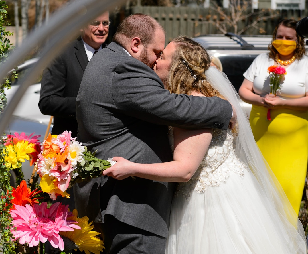 (Trent Nelson  |  The Salt Lake Tribune) Kadie and Tyler van Roosendaal have their first kiss after being married in a ceremony incorporating social distancing in a Salt Lake City yard on Saturday, April 4, 2020.