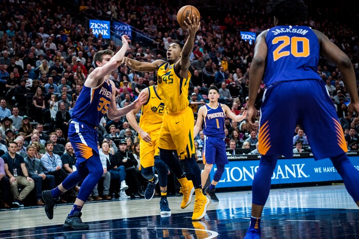 (Chris Detrick  |  The Salt Lake Tribune)  Utah Jazz guard Donovan Mitchell (45) shoots past Phoenix Suns forward Dragan Bender (35) during the game at Vivint Smart Home Arena Thursday, March 15, 2018. Utah Jazz defeated Phoenix Suns 116-88.