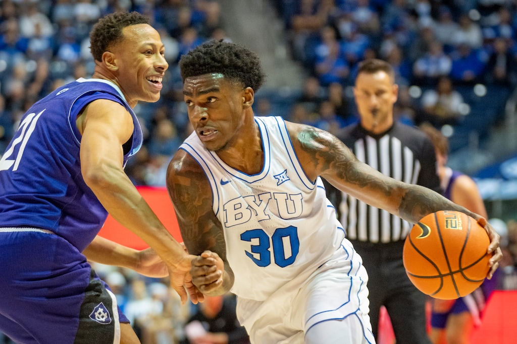 (Rick Egan | The Salt Lake Tribune) BYU Cougars Kennard Davis Jr. (30) gets past Holy Cross Crusaders guard Gabe Warren (21) on Nov. 8, 2025.

 